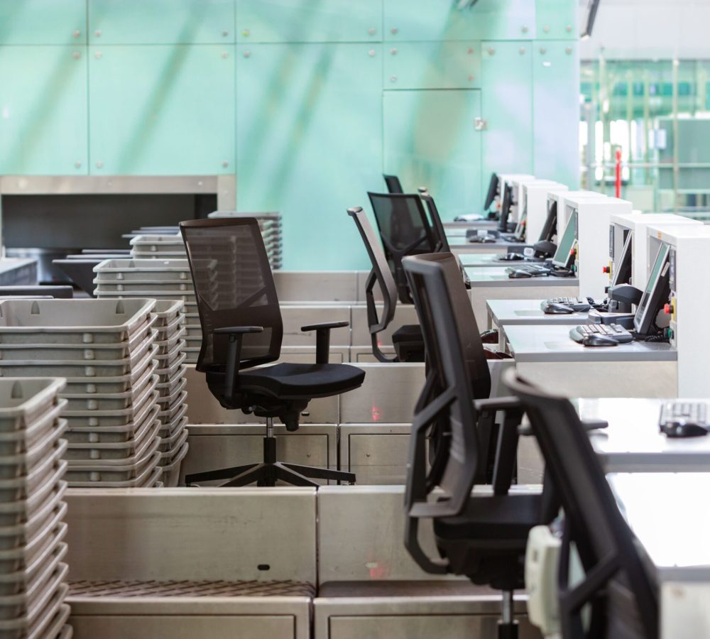 row-of-check-in-desks-with-computer-monitors-at-em-2023-11-27-04-52-58-utc